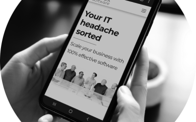 Hands holding a mobile phone and looking at the Redox Software home page