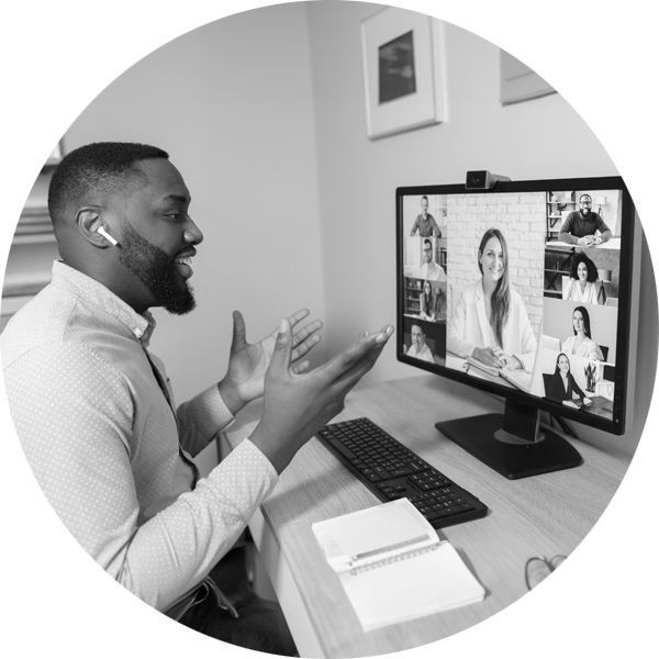 A man working from home on a video call with his team working from home and the office